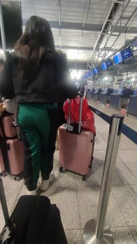 October 26 2024 Prague Czech Republic Europe,Vaclav Havel Airport three pink suitcases, luggage hand girls, travel objects, tourism. High quality photo