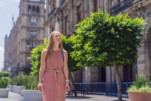 Female tourist in the central square of Mexico City, Zocalo. Cultural exploration, travel, and historic architecture concept.