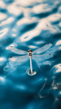 Elegant dragonfly perched on the surface of rippling blue water, its delicate wings and body creating a stunning contrast against the abstract patterns.