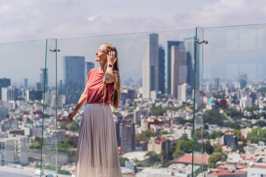 Female tourist or businesswoman standing on a skyscraper rooftop with a panoramic view of Mexico City. Travel or international business in Mexico concept.