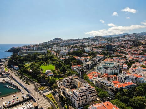 Aerial view of the coast of Funchal and the mountains around the city on the island of Madeira. High quality photo