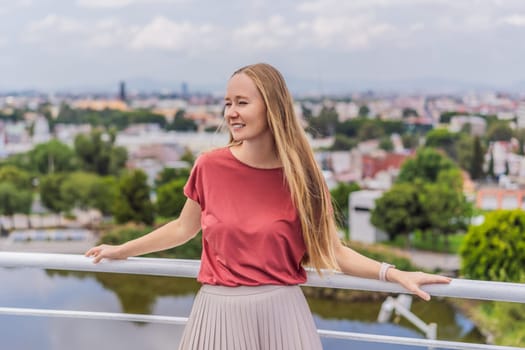 Female tourist in front of the panoramic view of Puebla city, Mexico. Travel, cultural exploration, and scenic landscape concept.
