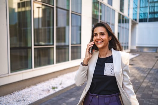 Businesswoman talking on a phone after work.