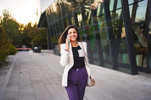 Businesswoman talking on a phone after work.