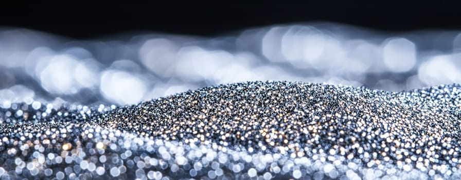shimmering landscape of silver and gold glitter creates mesmerizing effect.