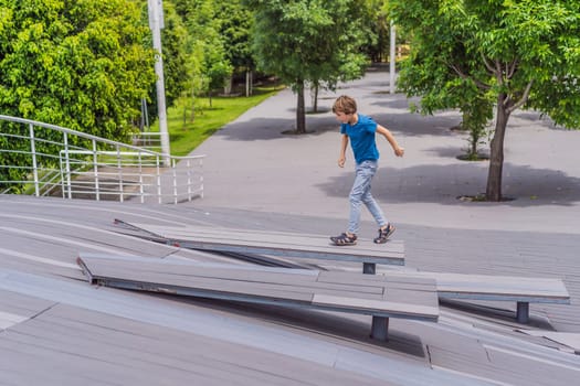Teenage boy doing parkour in a park. Adventure, movement, and urban sport concept.