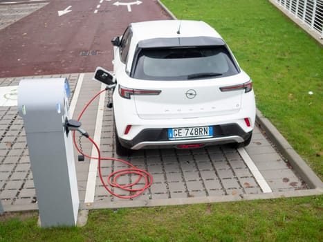 Cremona, Lombardy, Italy October 15th 2024 Modern electric car charging at a public charging station, promoting sustainable transportation and eco friendly practices