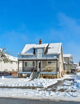 Small old family residential house on sunny winter day in Canada.
