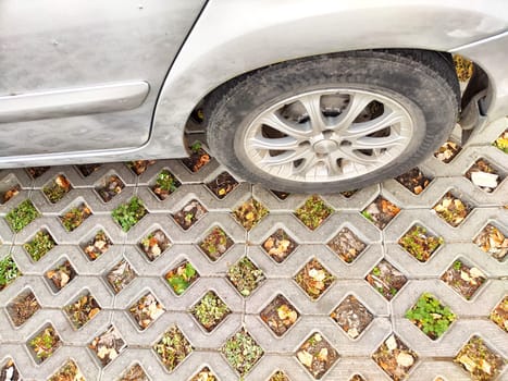 A vehicle parked on a permeable surface, showcasing eco-friendly design to support nature and reduce environmental impact.