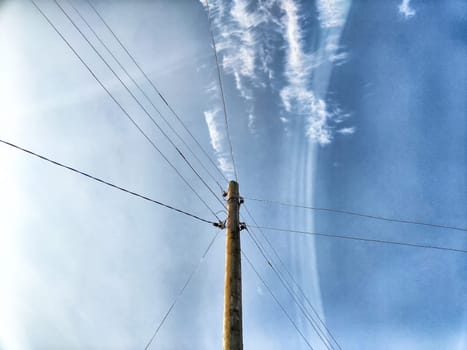 Old pole with wires against the sky. Electric transmission line, Eco-friendly energy