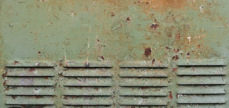 Rusty surface of louvre air vent. Detailed grungy texture of rusted steel ventilation grill. Weathered old panel with rust, chipped and peeling, aged iron, flaking fade green paint, corrosion details