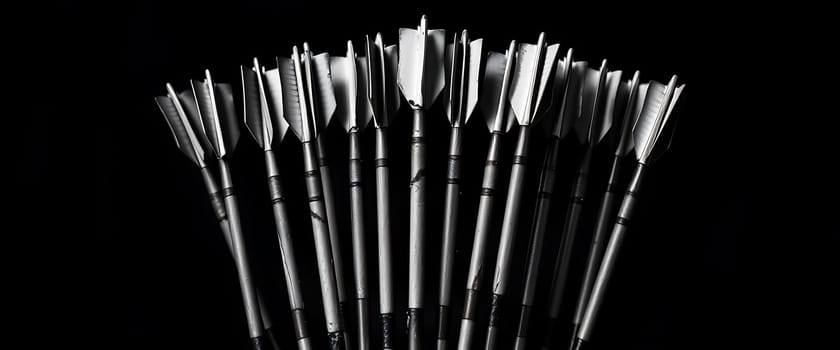 The image portrays a striking arrangement of arrows fanned out against a stark black background, creating a dramatic contrast that accentuates their sleek forms. The arrows' metallic points gleam with precision, evoking a sense of readiness and unity, as if poised for a collective purpose, exuding an aura of focus and determination.
