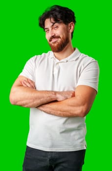 A young man with a beard showing a serious expression against a vibrant green background close up