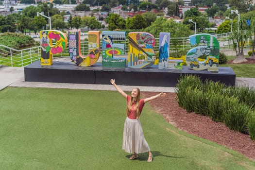 Female tourist in front of the panoramic view of Puebla city, Mexico. Travel, cultural exploration, and scenic landscape concept.