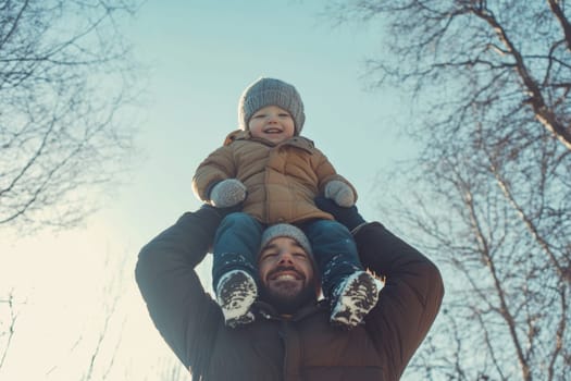 Caucasian middle-aged man in casual clothes with his little son on his neck standing against the background of snowy forest in winter. High quality photo