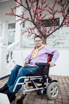 Man sitting in a wheelchair on a walk in the city