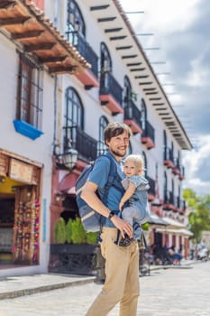Father and his son tourists walks through the colonial streets San Cristobal de las Casas, Mexico. Cultural exploration, architecture, and travel experience concept.