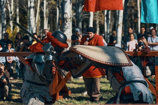 Imitation of medieval jousting. The battle of two knights with swords. Reconstruction of the historical tournament. Bishkek, Kyrgyzstan - October 13, 2019