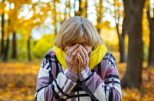 Senior woman in autumn park. Selective focus. nature.