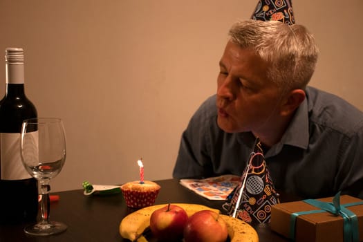 Mid aged man celebrating alone.