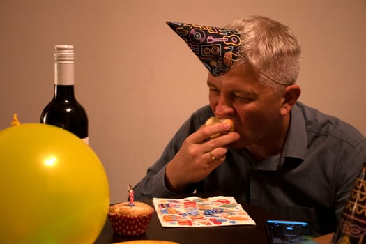 Mid aged man celebrating alone.