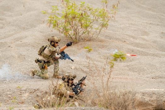 One of military or soldier throw flare on fire to the front to give signal to his support team for fighting during outdoor practice.