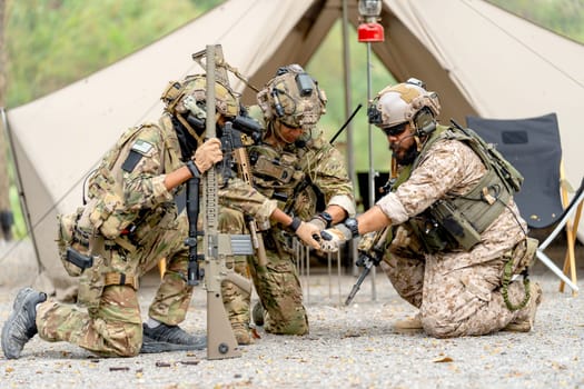 Group of militaries or soldiers stay in front of tent also do first bump during outdoor practice.