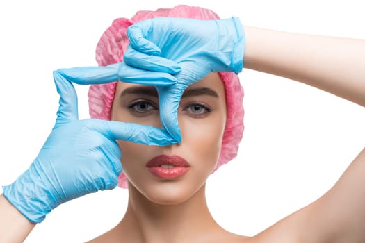 Woman in disposable cap and gloves at plastic surgeon isolated shot on white background