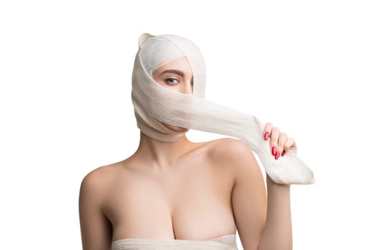 Beautiful woman with bandaged face after plastics isolated shot on white background