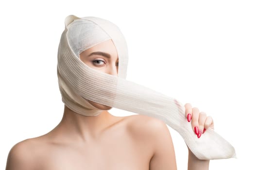 Woman her head and neck bandaged at plastic surgeon isolated shot on white background