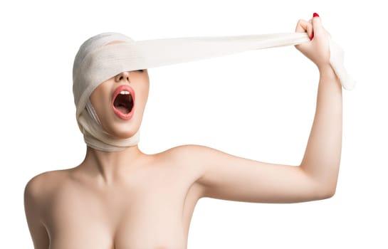 Beautiful girl taking off bandage from her face after plastics isolated shot on white background