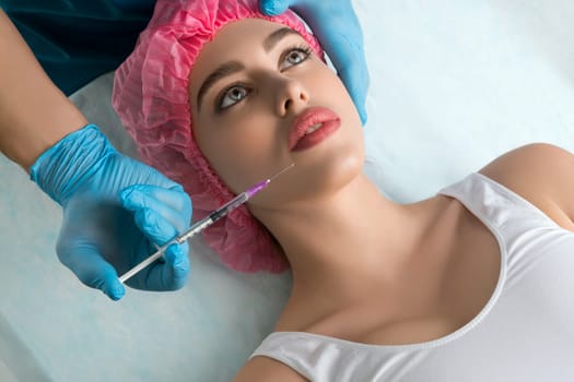 Girl her head and neck bandaged at plastic surgeon lip injection high angle shot