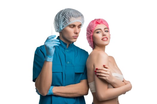 Handsome plastic surgeon holding a syringe in his hand and pretty patient isolated portrait on white background