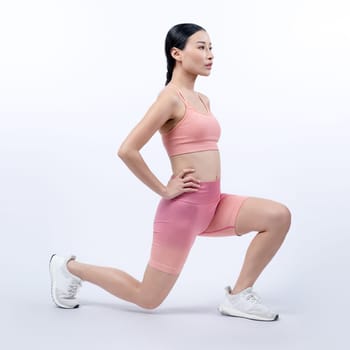 Young attractive asian woman in sportswear stretching before fitness exercise routine. Healthy body care workout with athletic woman warming up on studio shot isolated background. Vigorous