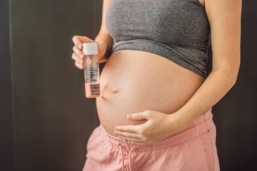 Turkiye, Antalya 02.02.2022: Woman holds Bio Oil, a nurturing choice for pregnant women. A soothing image of care and wellness during pregnancy.