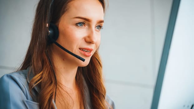 Business people wearing headset working in office to support remote customer or colleague. Call center, telemarketing, customer support agent provide service on telephone video conference call. Jivy