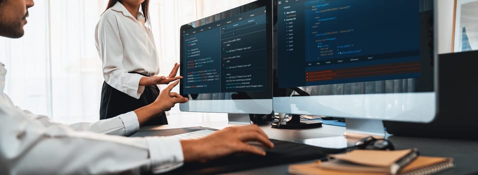 Software development team working together in office, coding script display on computer monitor. Programmer and software engineer working in tech developer company. Trailblazing