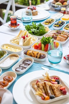 Traditional Turkish Breakfast served with traditional turkish tea on wooden table