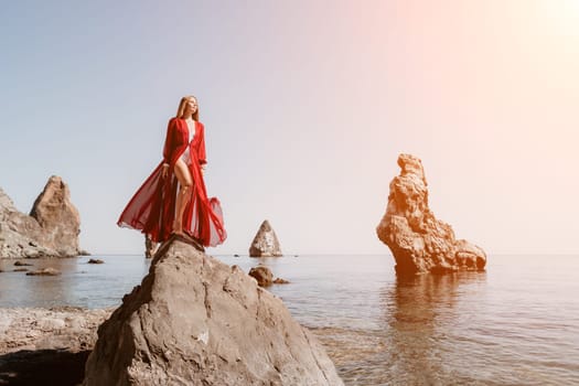 Woman travel sea. Happy tourist taking picture outdoors for memories. Woman traveler looks at the edge of the cliff on the sea bay of mountains, sharing travel adventure journey.