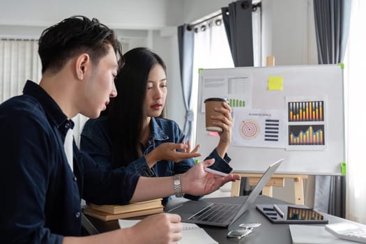 two business people talk project strategy at office meeting room. businessman discuss project planning with colleague at modern workplace while having conversation.