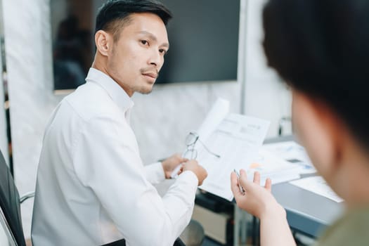 Asian business advisor meeting to analyze and discuss the situation on the financial report in the meeting room.Investment Consultant, Financial , teamwork ,brainstorming ,startup and accounting.