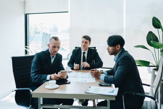 Asian business advisor meeting to analyze and discuss the situation on the financial report in the meeting room.Investment Consultant, Financial , teamwork ,brainstorming ,startup and accounting.