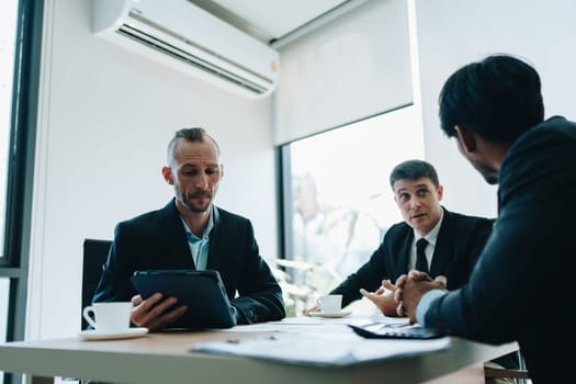 Asian business advisor meeting to analyze and discuss the situation on the financial report in the meeting room.Investment Consultant, Financial , teamwork ,brainstorming ,startup and accounting.