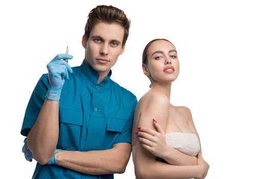 Handsome plastic surgeon with his female patient isolated view on white background