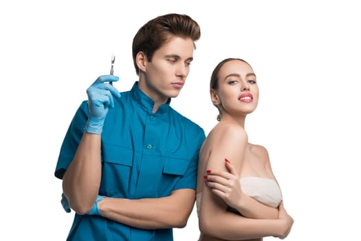 Plastic surgeon holding a syringe with his female beautiful patient isolated cropped view on white background