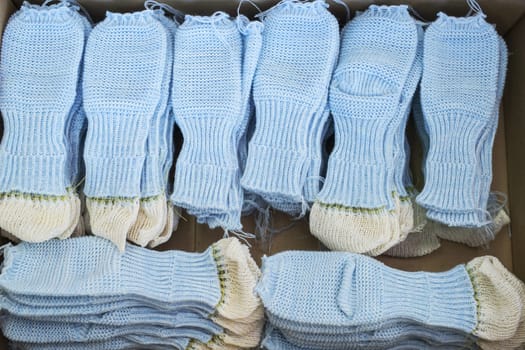 Knitted blue ready socks workpieces at a knitting shop view