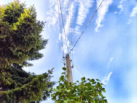 Old pole with wires against the sky. Electric transmission line, Eco-friendly energy