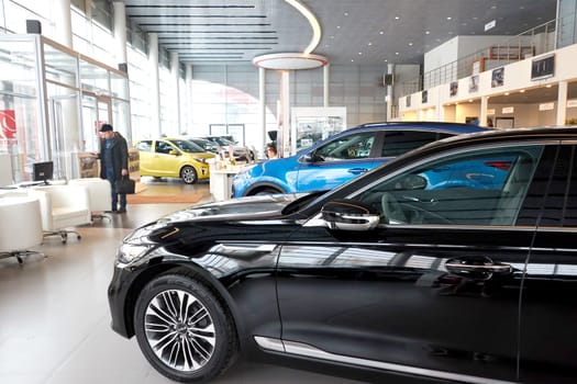 Kazan, Russia - November 25, 2022: Cars in showroom of dealership Kia in Kazan in Russia. Partial focus