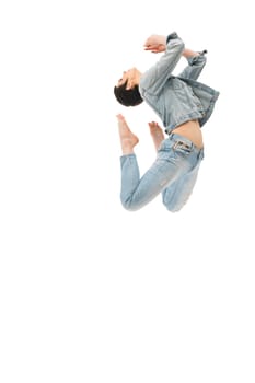 Brunette with shot haircut in jeanswear jumping gracefully isolated shot on white background