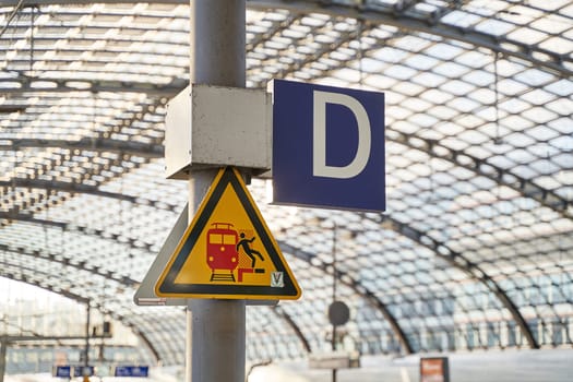 Berlin, Germany - Oct 23, 2024: Be careful at the edge of the platform sign of Deutsche Bahn, the national railway company of Germany, at Berlin Hauptbahnhof aka Berlin Central Station